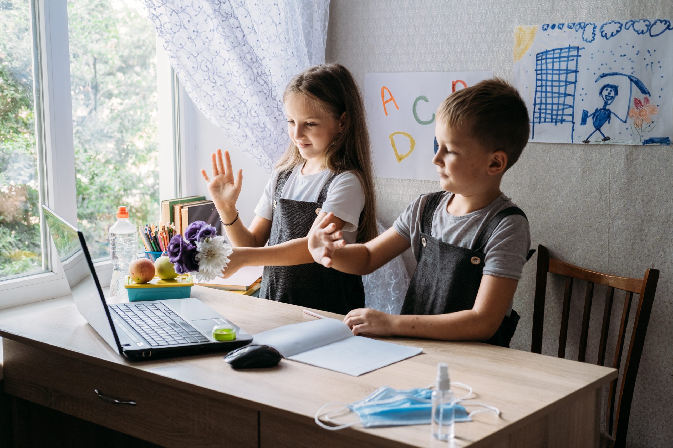 Schoolkids boy and girl using laptop for online study during homeschooling at home. Homeschooling, online study, home quarantine online learning education corona virus or online technology