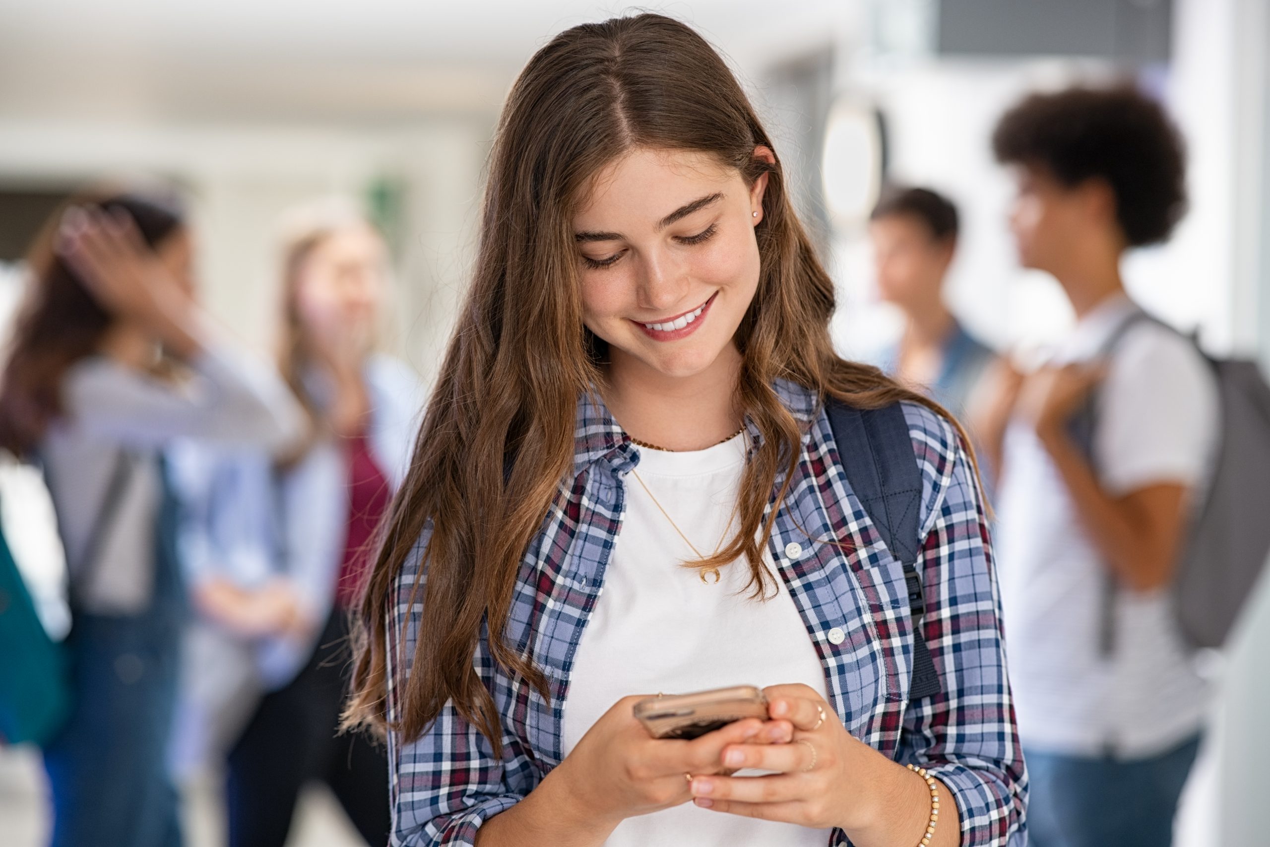 Girl in college school using smartphone
